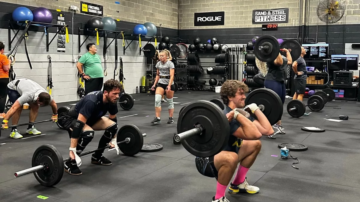 Coach-led Fitness Class at Sand & Steel Fitness in Alexandria VA — athletes training barbell movements in a small group session